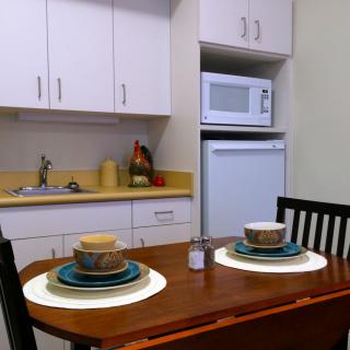 A cozy kitchen setup with a dining table arranged for two.