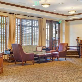 A cozy living room with comfortable seating and large windows.