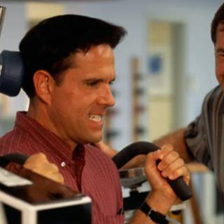 Two men working out at the gym, focusing on strength training.