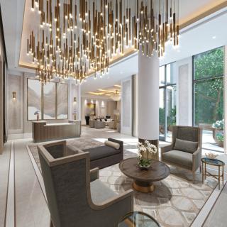 A luxurious lobby featuring modern seating, a grand chandelier, and large windows.