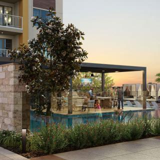A modern outdoor space with a pool and seating area at sunset.
