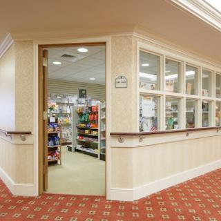 A glimpse into a retail space with shelves filled with products, seen through an open doorway.