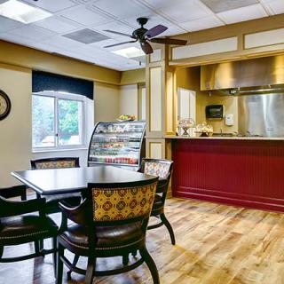 Cozy cafe interior with seating and a counter.