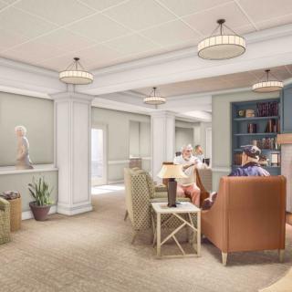 A cozy living room with comfortable seating, bookshelves, and soft lighting.