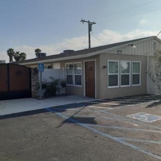 A small suburban building with handicap parking in front.