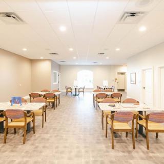 A spacious and well-lit dining area with tables and chairs arranged neatly.