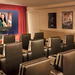 A cozy home theater with comfortable seating and classic movie posters adorning the walls.
