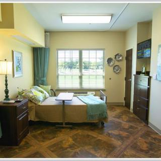 A cozy, well-lit hospital room with stylish decor and comfortable furnishings.