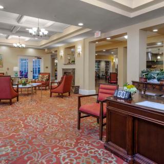 A spacious and elegantly designed lobby with comfortable seating and a reception desk.