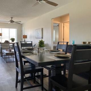 A modern dining room with a sleek table and chairs, tastefully set for a meal.