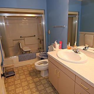 A bathroom with a vanity sink, toilet, and bathtub.