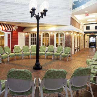 A cozy indoor meeting space with arranged chairs and a decorative lamp post.