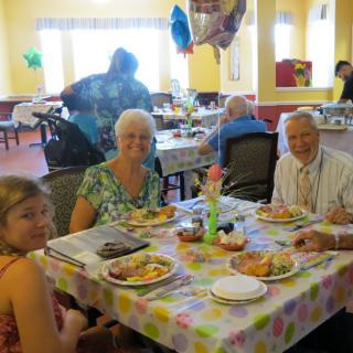 A family enjoying a meal together at a festive restaurant setting.