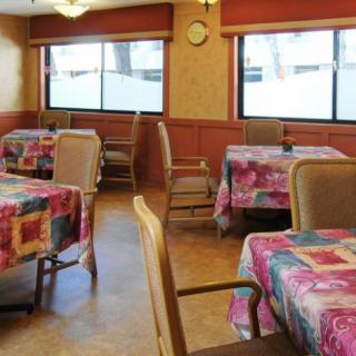 A cozy dining room with colorful tablecloths and natural lighting.