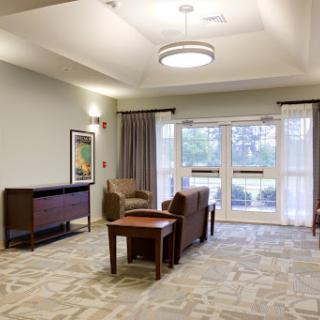 A comfortable lounge area featuring modern furniture and ample natural light.