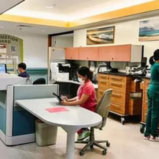 A hospital reception area with medical staff working on computers.