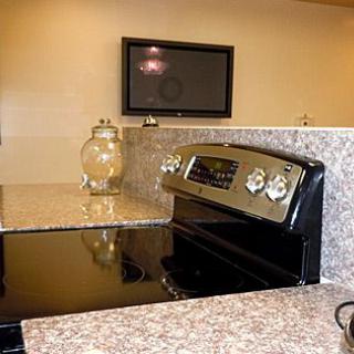 Modern kitchen with a granite countertop and built-in stove.