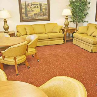 A cozy living room with yellow furniture and warm lighting.