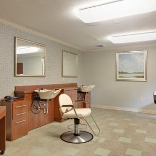 A modern and clean hair salon interior featuring styling chairs and mirrors.