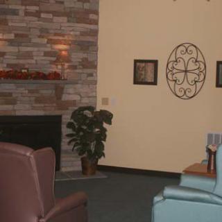 A cozy living room with a fireplace, comfortable seating, and decorative elements.