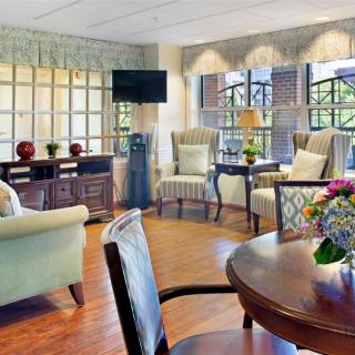 A cozy living room with comfortable seating, a television, and ample natural light.