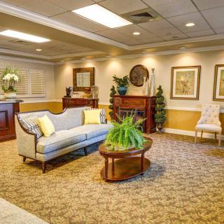 Cozy and elegantly decorated lobby with seating area and artwork on the walls.