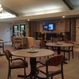 A cozy lounge area featuring tables and chairs, perfect for social gatherings.