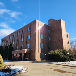 A modern brick building under a clear blue sky, showcasing architectural design.