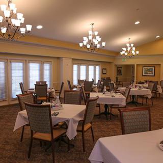 An elegantly arranged dining room with tables set for guests.