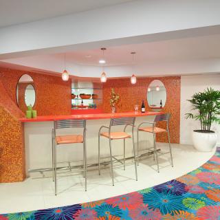 A modern and colorful bar interior with vibrant decor and stylish seating.