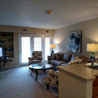 A cozy living room with modern furniture, artwork, and soft lighting.
