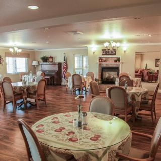 A cozy dining room with elegantly set tables and ambient lighting.