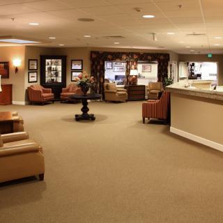 A spacious lobby with comfortable seating and a reception desk.