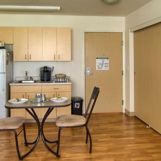 A cozy kitchen and dining area with a small table set for two.