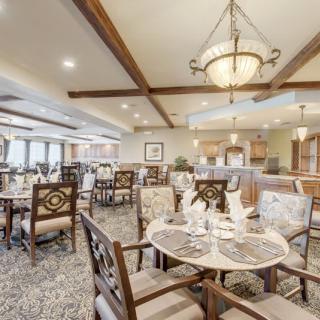 A well-decorated dining area with elegant lighting and comfortable seating arrangements.