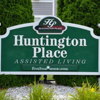 A sign for Huntington Place Assisted Living, indicating residential care services.