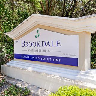 A sign for Brookdale Senior Living Solutions situated outdoors.