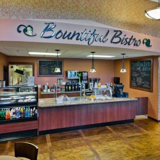 Interior view of a cafe named Bountiful Bistro, showcasing the counter and menu area.