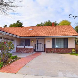 A single-story suburban house with a tiled roof and a spacious driveway.