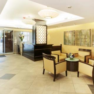 A modern lobby with comfortable seating, contemporary artwork, and elegant lighting.