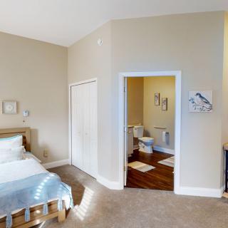 A cozy bedroom interior with an adjacent bathroom.