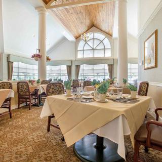 An elegantly designed restaurant dining area with tables set for guests.