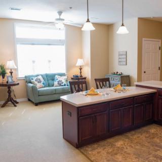 A cozy open-concept kitchen and living room with a central island and comfortable seating.