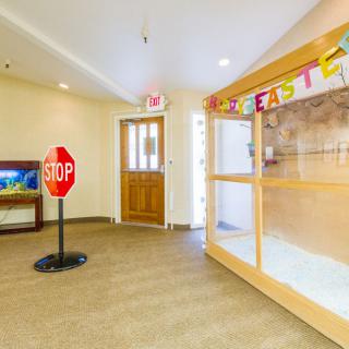 A brightly decorated daycare interior featuring a stop sign and colorful banners.