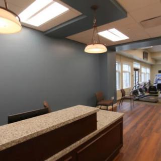 A modern office reception area with a desk and seating.