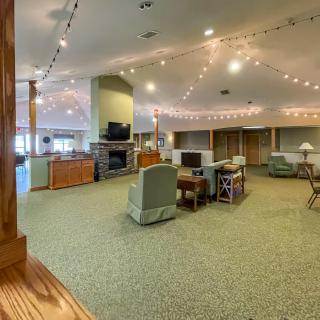 A spacious interior with comfortable seating, a fireplace, and warm lighting.