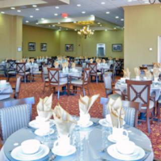 A spacious and elegantly arranged dining room, ready for guests.