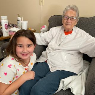 A joyful moment shared between a young girl and her grandmother.