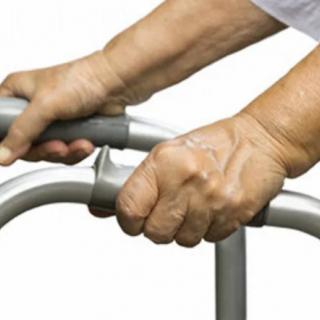 Hands gripping a walker, providing support for mobility.