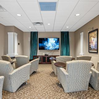 A cozy home theater with comfortable seating and a large screen TV.